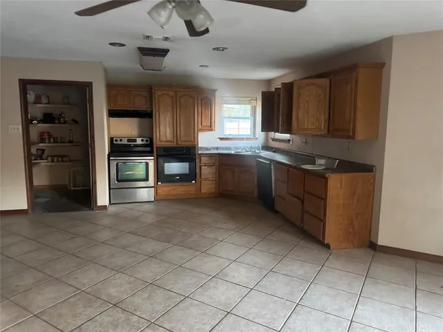 a view of a yard in front of a house with large trees