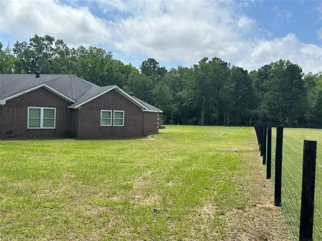 a house with green field in front of it
