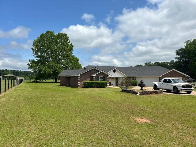 a big house with a big yard and large trees
