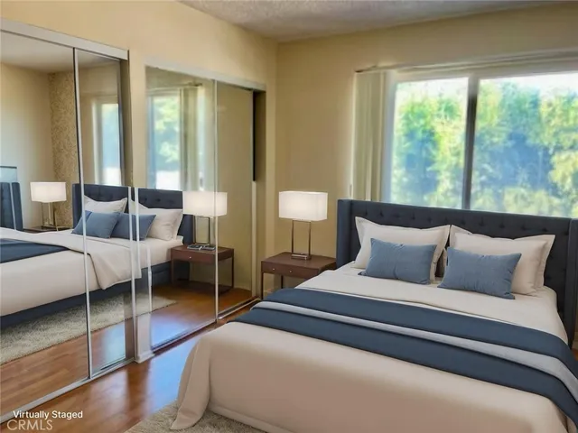 a bedroom with bed and large window