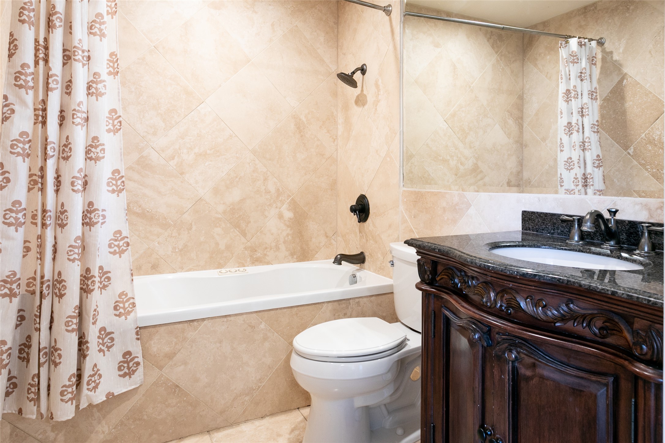 500 East Riverside Drive, Unit 224 Austin, TX 78704 - Photo 14 of 19 Elegant tile work surrounds a pristine bathtub and shower in this well-appointed bathroom.