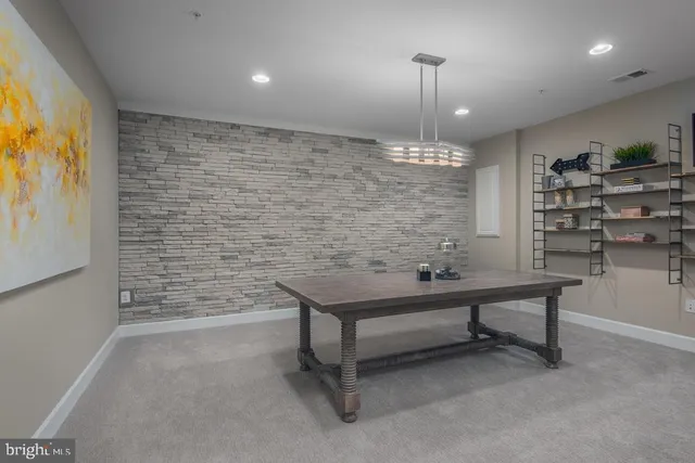 a open kitchen with center island white cabinets and stainless steel appliances