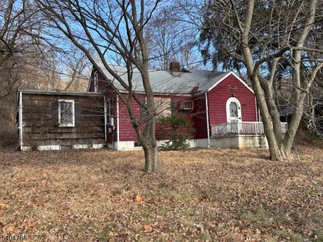 a view of a house with a yard covered the snow