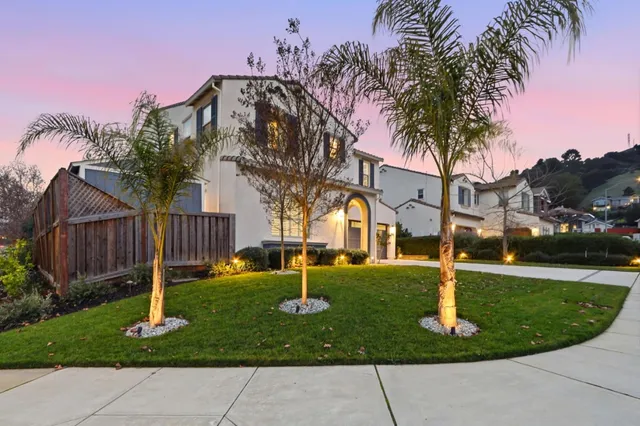 a front view of a house with swimming pool and porch