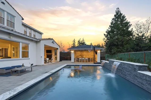 a large bathroom with a granite countertop sink a bathtub a mirror and vanity