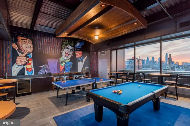 a room with furniture pool table and a large window