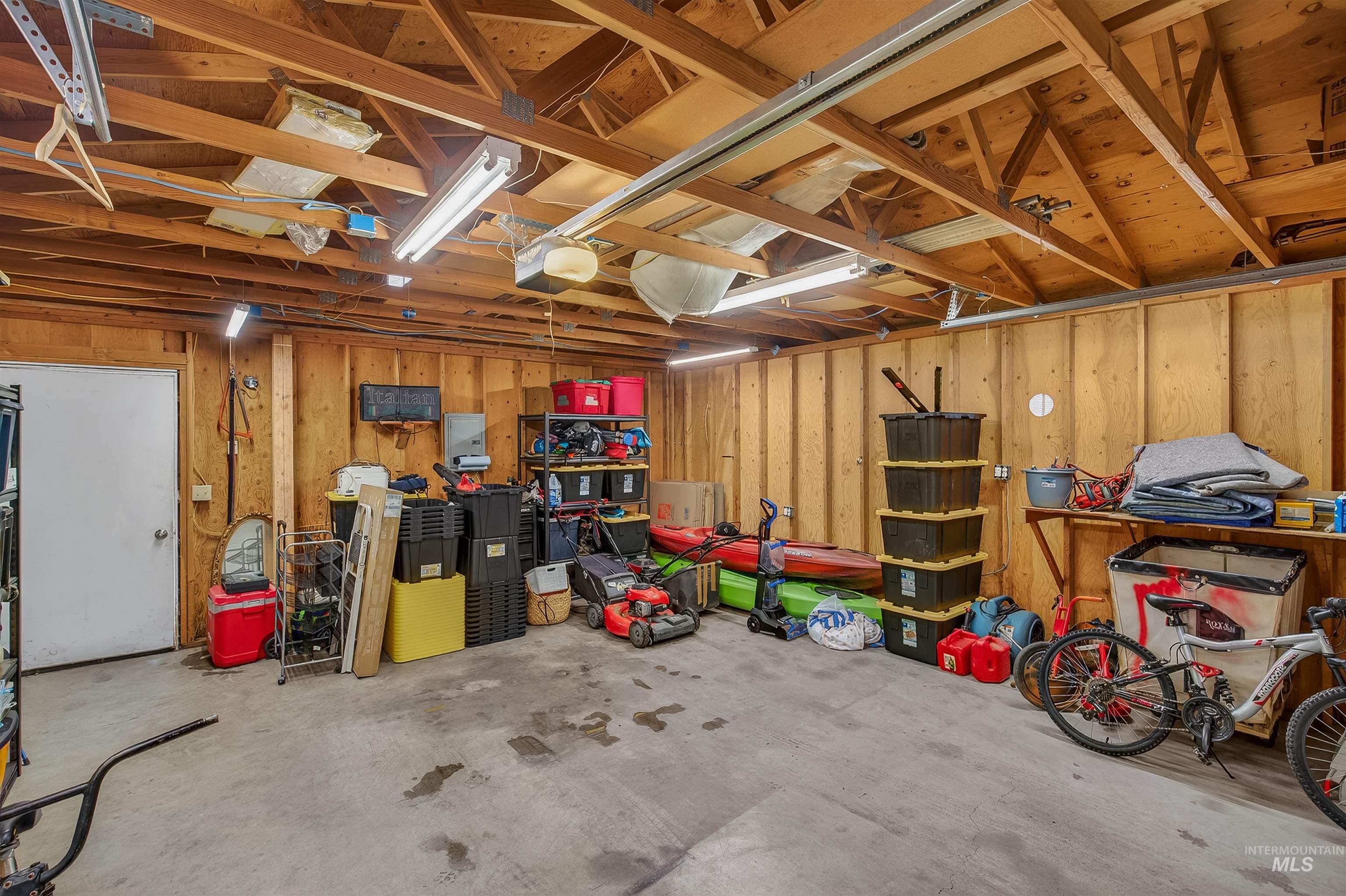 835 12th Street Clarkston, WA 99403 - Photo 33 of 39 Garage with wooden walls and a garage door opener