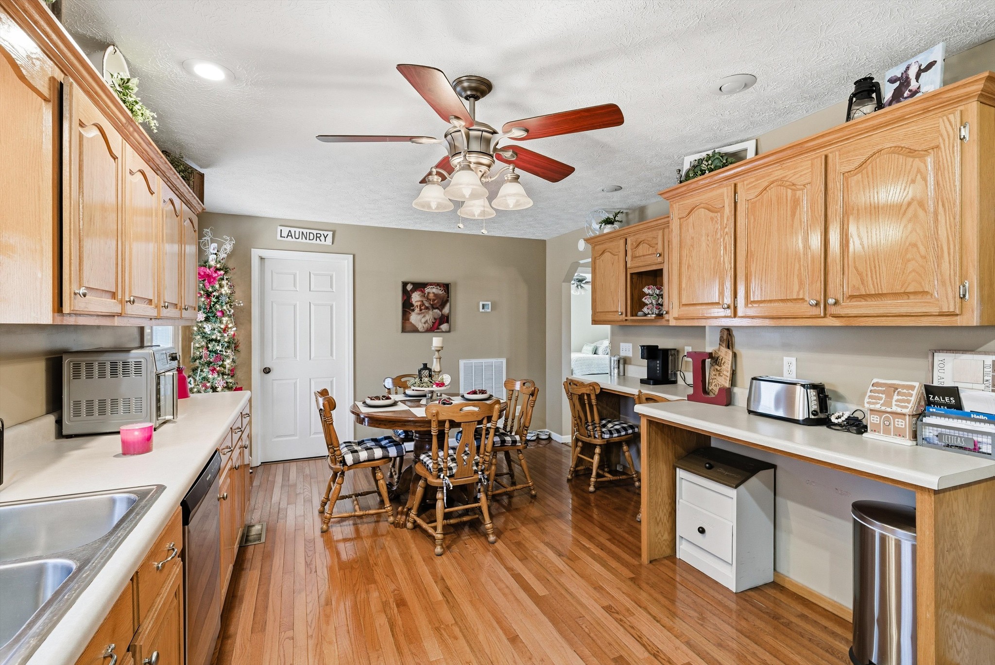 450 Poss Road Smithville, TN 37166 - Photo 8 of 33 a kitchen with stainless steel appliances granite countertop a stove top oven a refrigerator a dining table and chairs with wooden floor