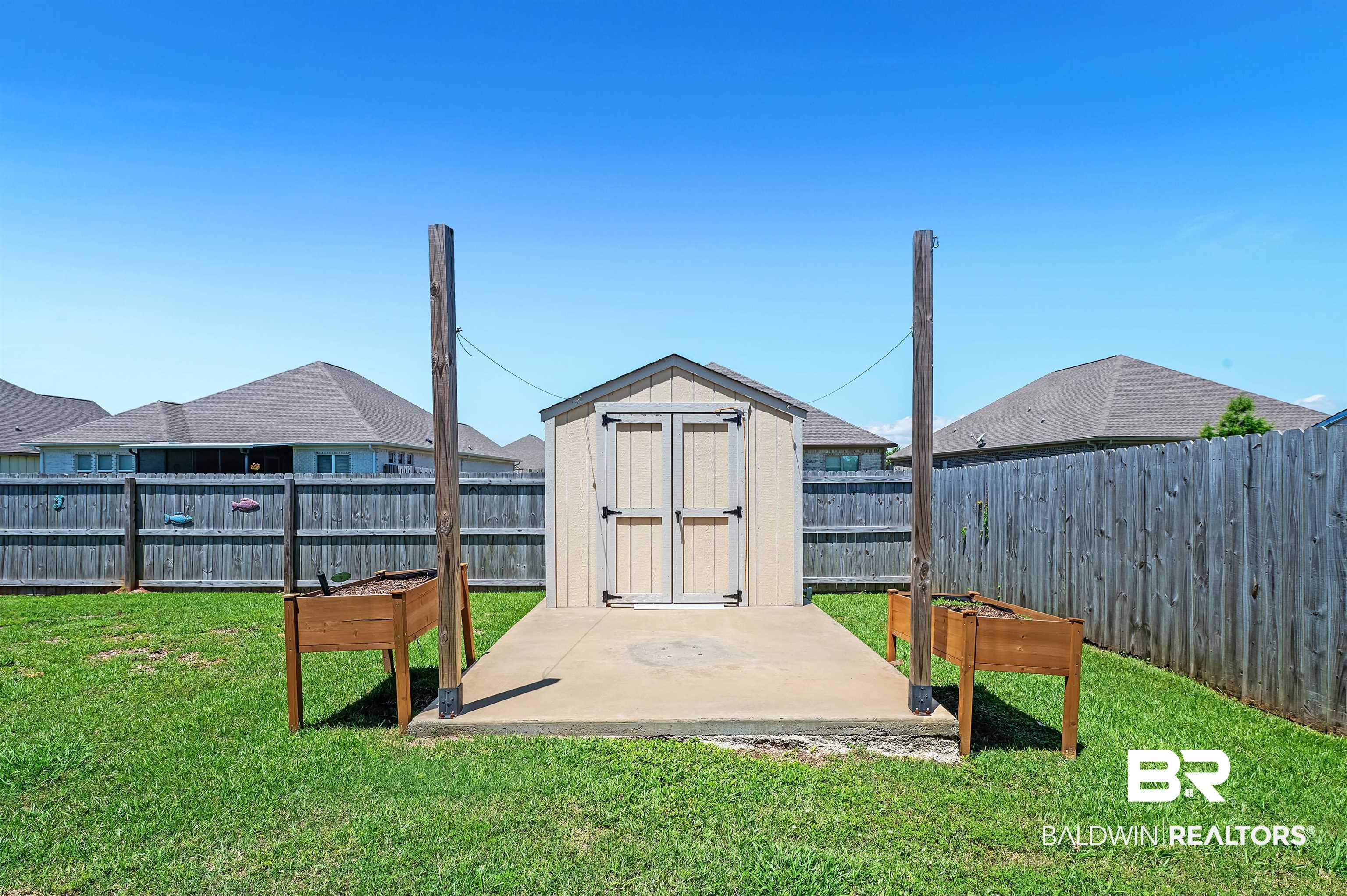 24655 Slater Mill Road Daphne, AL 36526 - Photo 33 of 36 View of yard featuring a patio, a storage shed, and an outbuilding