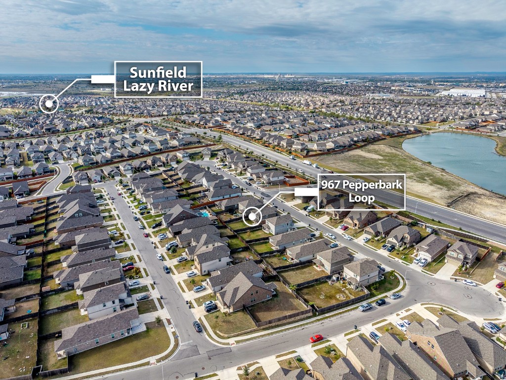 967 Pepperbark Loop Buda, TX 78610 - Photo 28 of 29 Aerial overview of property's location featuring nearby suburban area and a large body of water