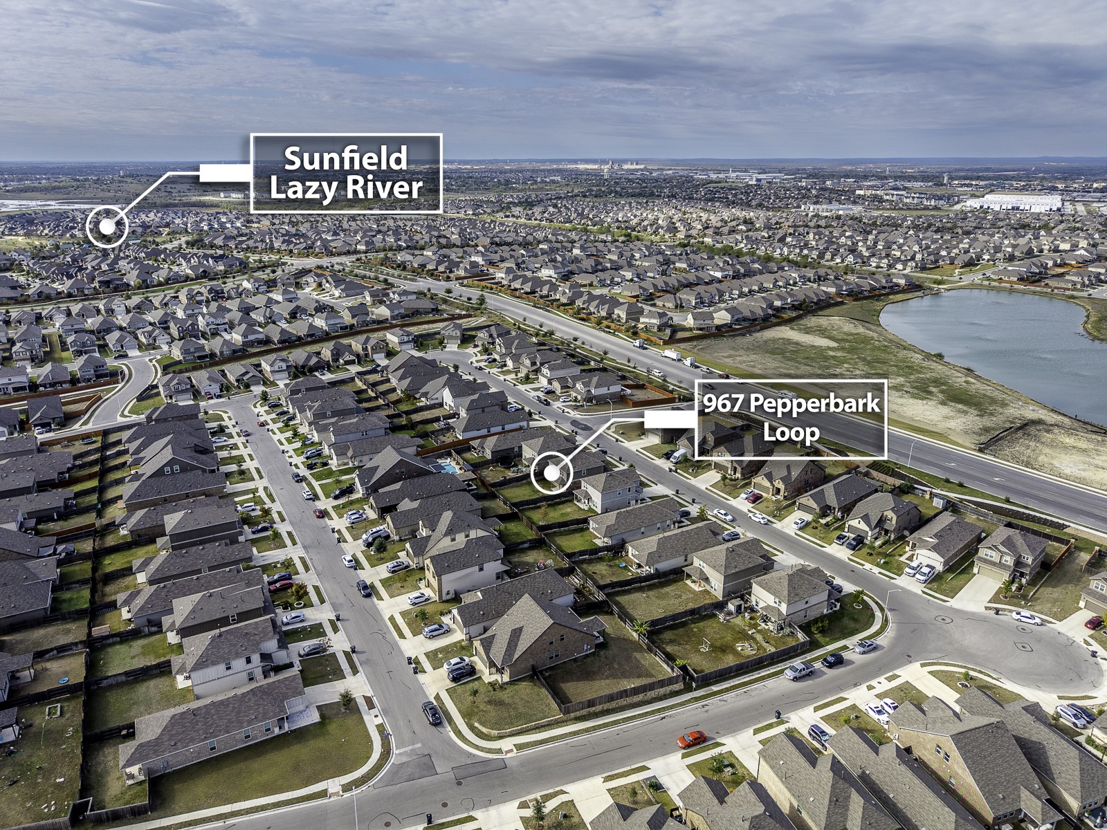 967 Pepperbark Loop Buda, TX 78610 - Photo 28 of 29 Aerial overview of property's location featuring nearby suburban area and a large body of water