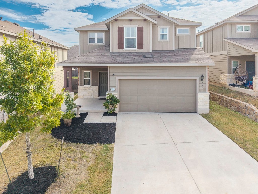 967 Pepperbark Loop Buda, TX 78610 - Photo 3 of 29 Craftsman house with board and batten siding, stone siding, and a porch