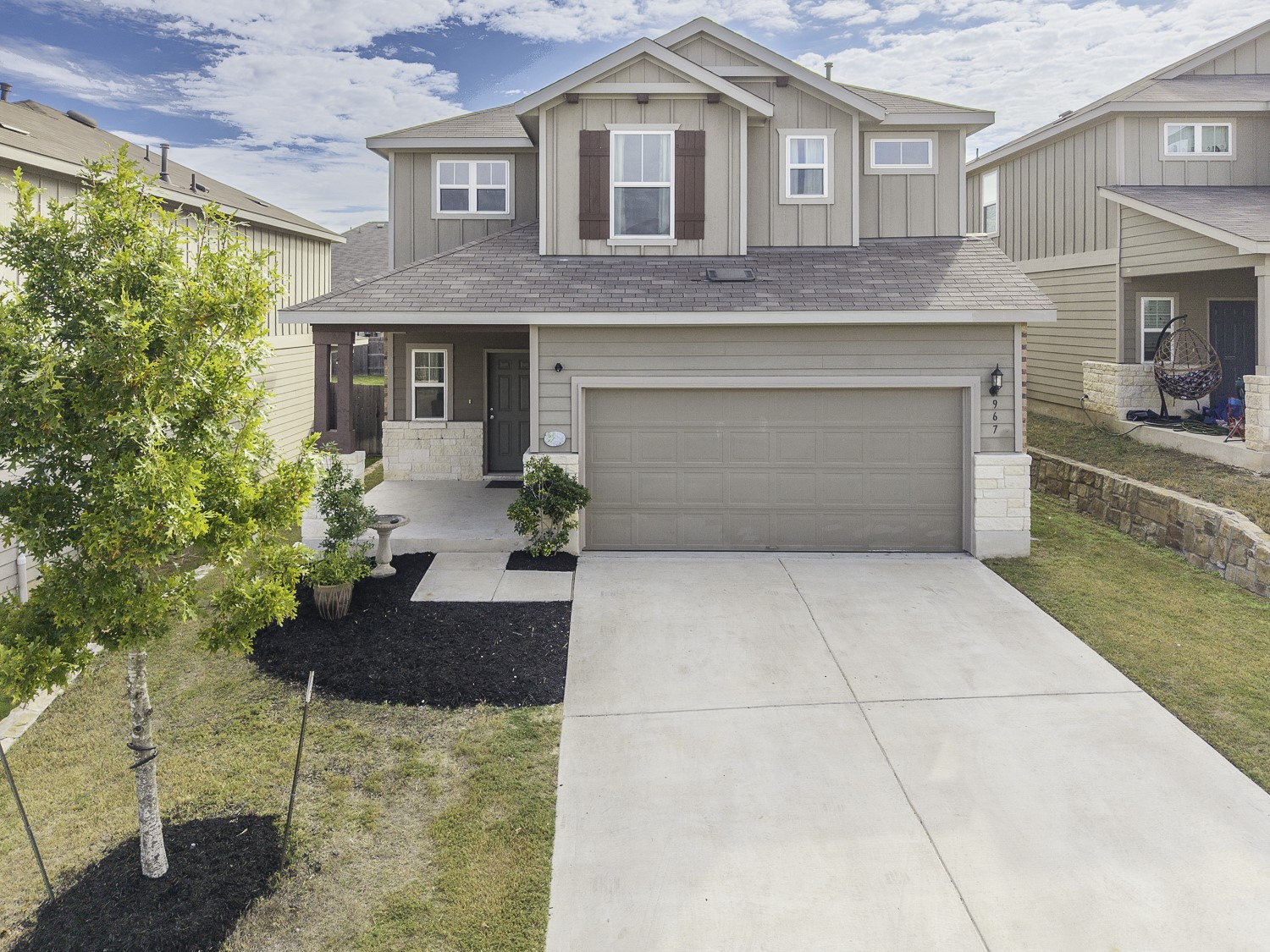967 Pepperbark Loop Buda, TX 78610 - Photo 3 of 29 Craftsman house with board and batten siding, stone siding, and a porch