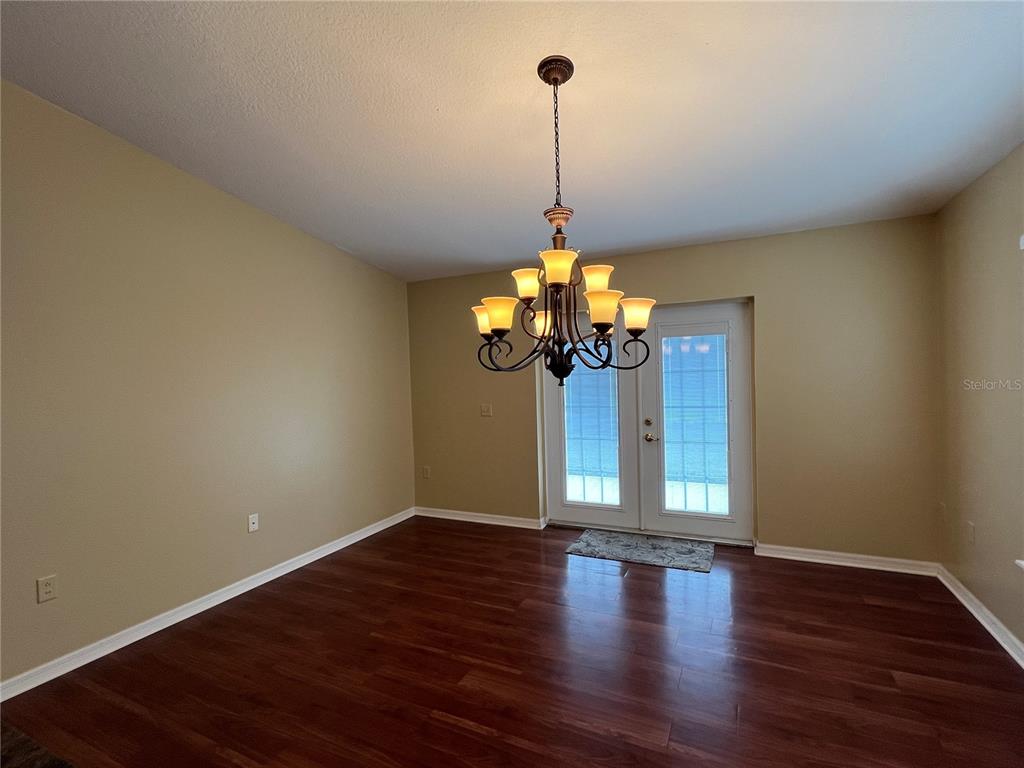14367 Finsbury Drive Spring Hill, FL 34609 - Photo 11 of 35 a view of a room with wooden floor chandelier and entryway