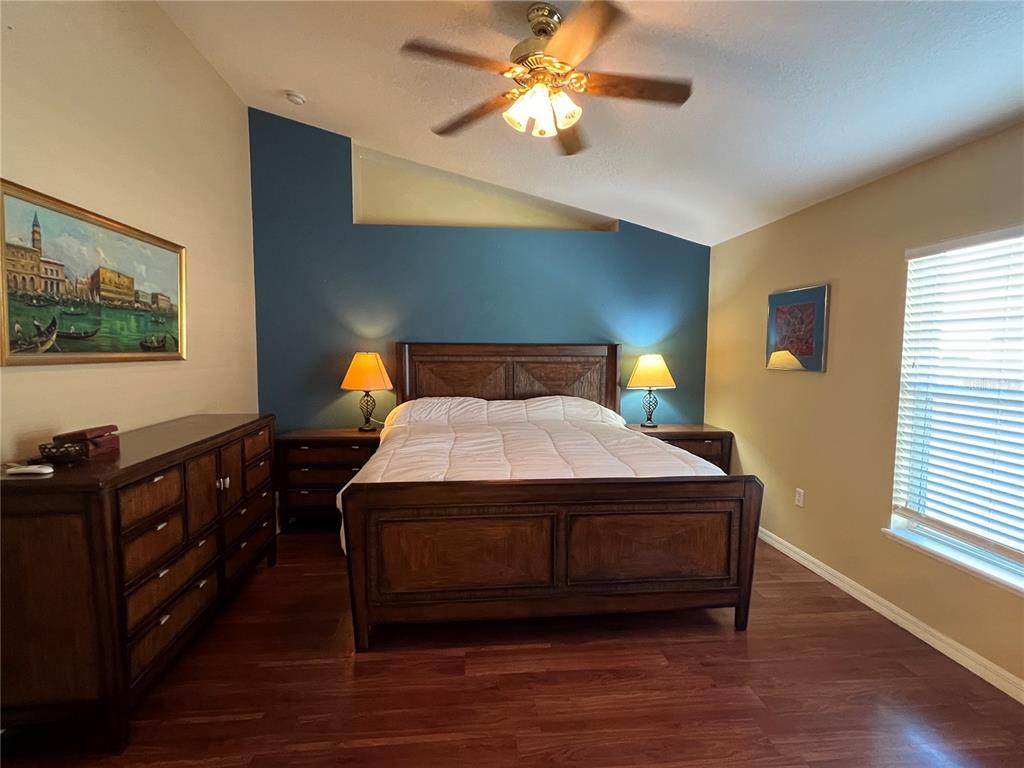 14367 Finsbury Drive Spring Hill, FL 34609 - Photo 13 of 35 a bedroom with a bed and wooden floor