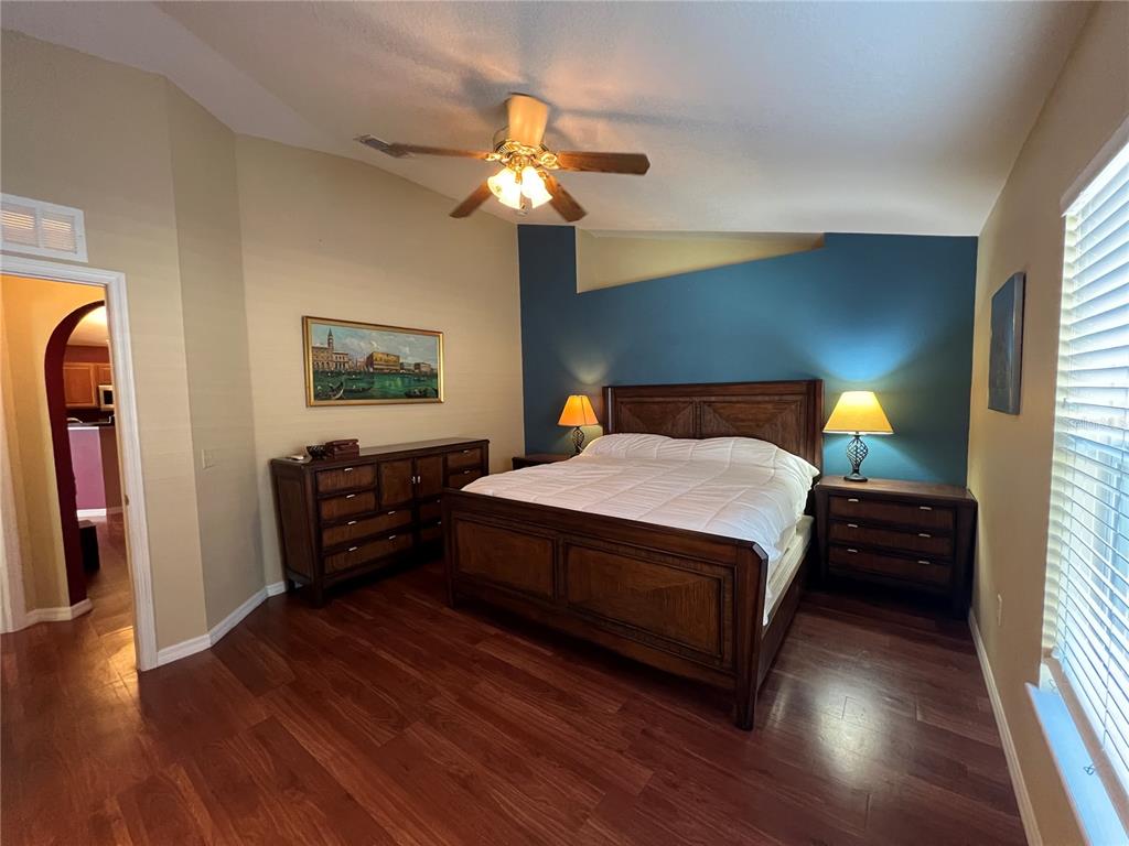 14367 Finsbury Drive Spring Hill, FL 34609 - Photo 15 of 35 a bedroom with a bed and wooden floor