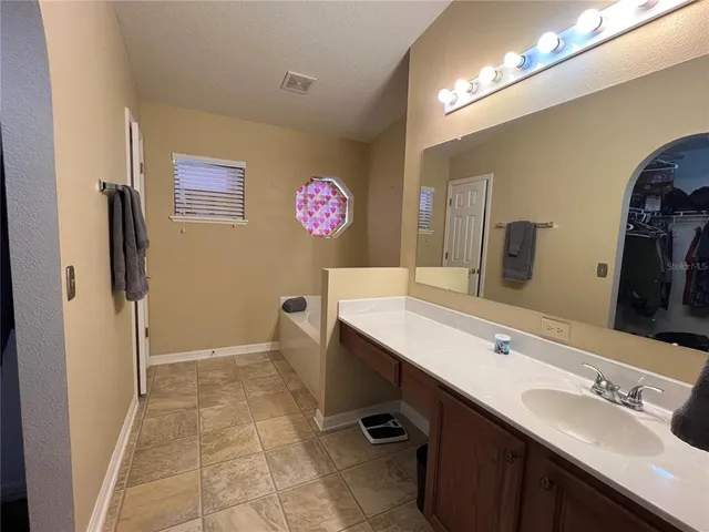 a bathroom with a sink a mirror and a shower
