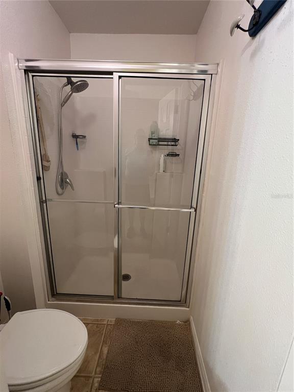 14367 Finsbury Drive Spring Hill, FL 34609 - Photo 17 of 35 a bathroom with a shower and a toilet