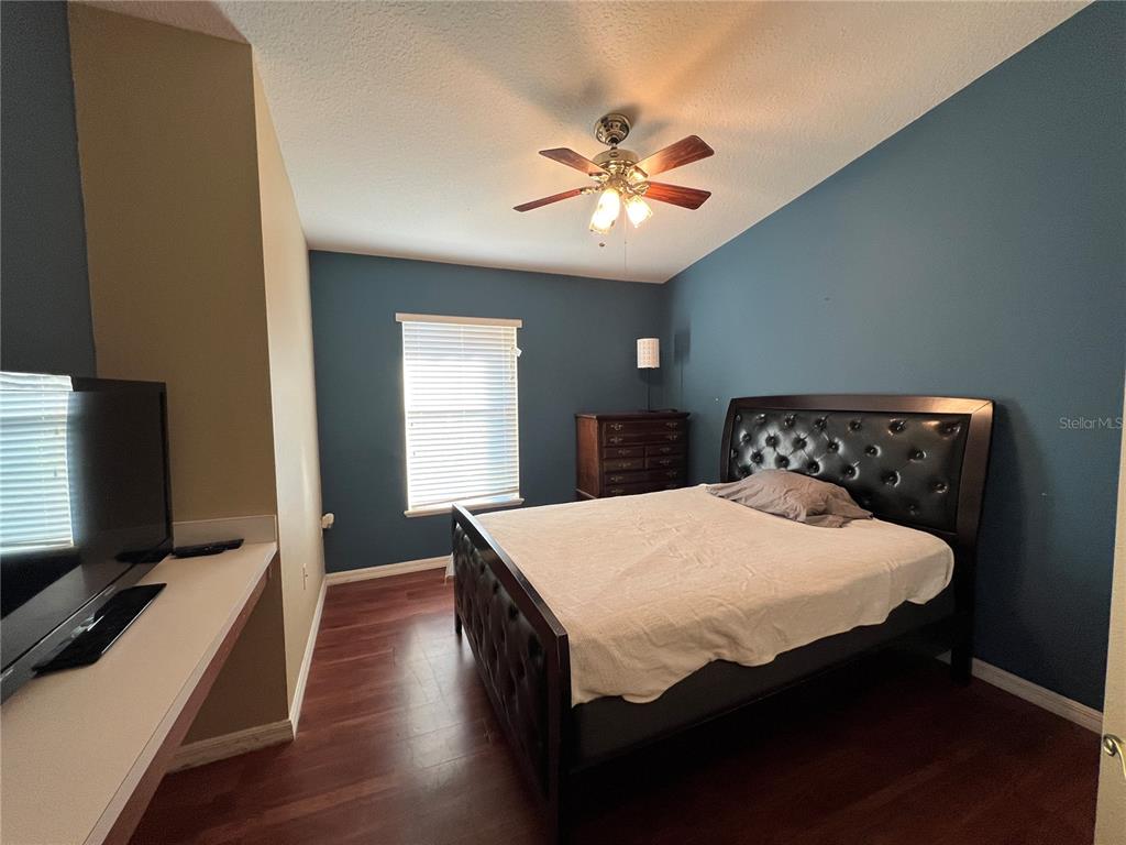 14367 Finsbury Drive Spring Hill, FL 34609 - Photo 20 of 35 a bedroom with a bed and a flat screen tv