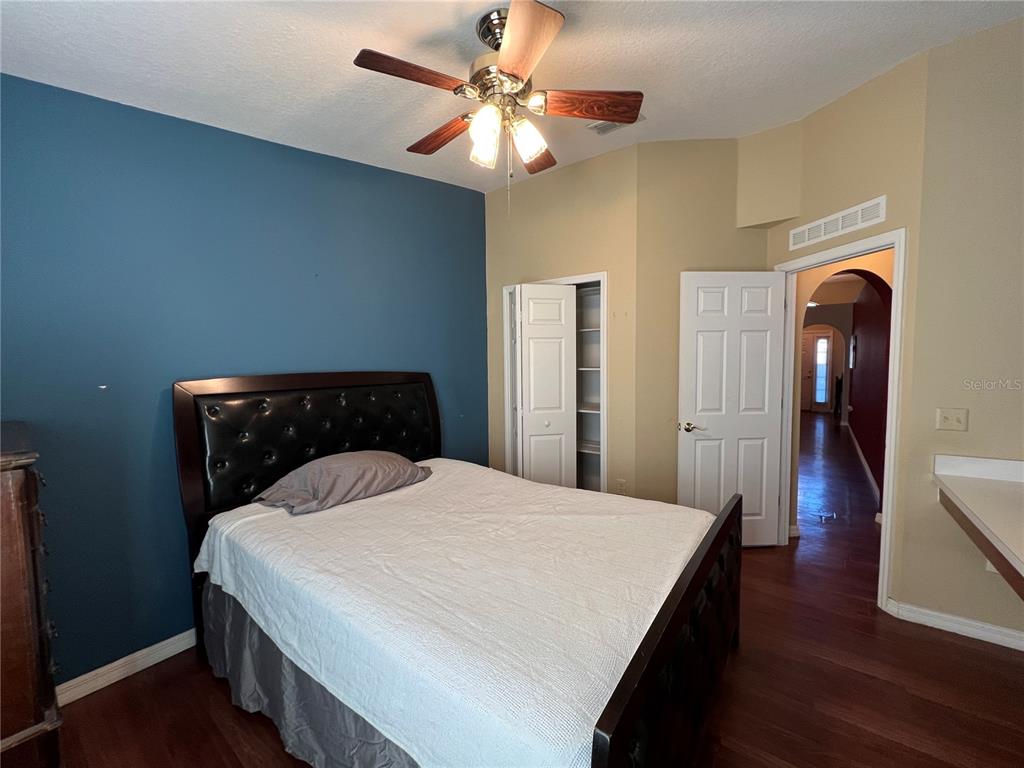 14367 Finsbury Drive Spring Hill, FL 34609 - Photo 22 of 35 a bedroom with a bed and wooden floor