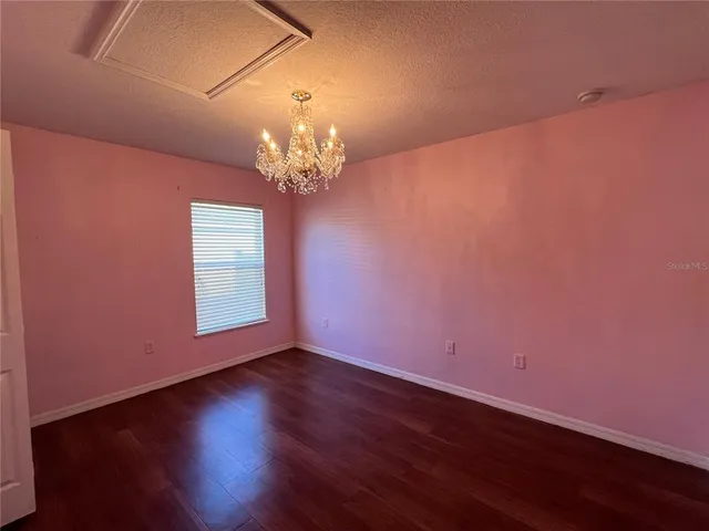 a view of wooden floor and windows in a room
