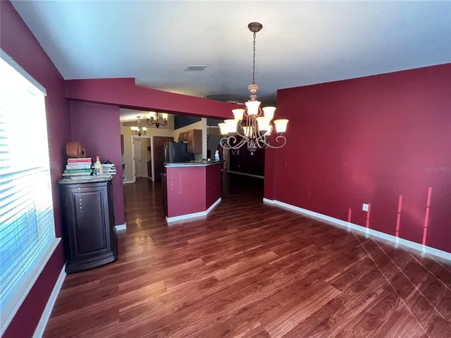 a view of a dining room with furniture and chandelier