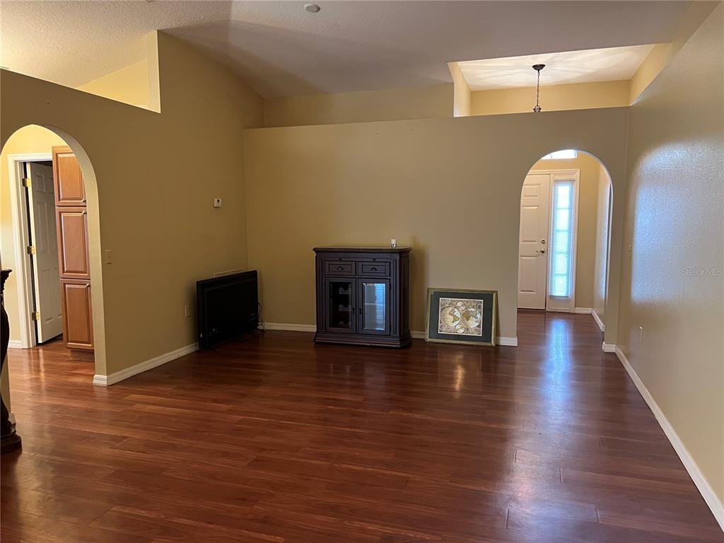 14367 Finsbury Drive Spring Hill, FL 34609 - Photo 8 of 35 an empty room with wooden floor and windows