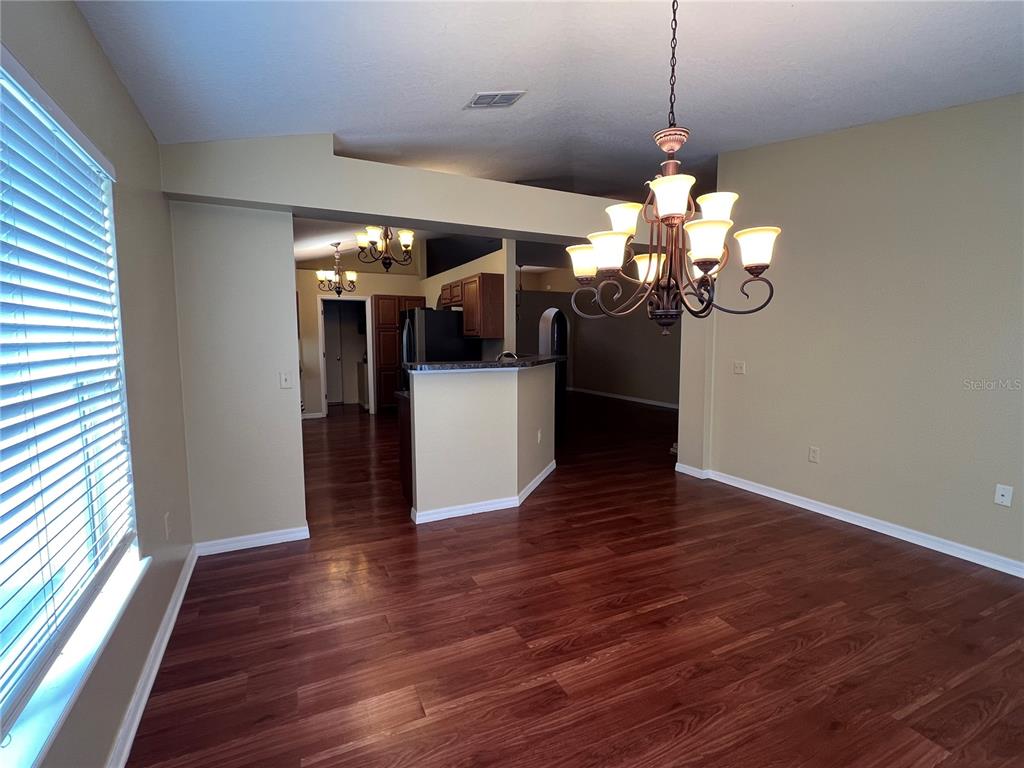14367 Finsbury Drive Spring Hill, FL 34609 - Photo 10 of 35 a view of a room with wooden floor and windows