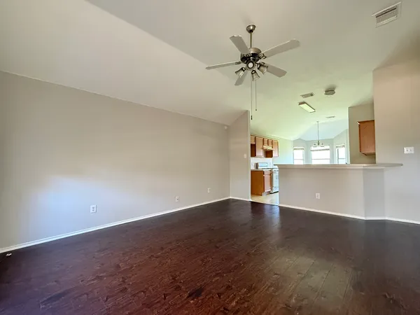 a view of a kitchen with a dishwasher cabinets and a wooden floor