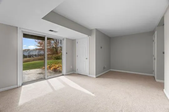 a view of an empty room with glass door