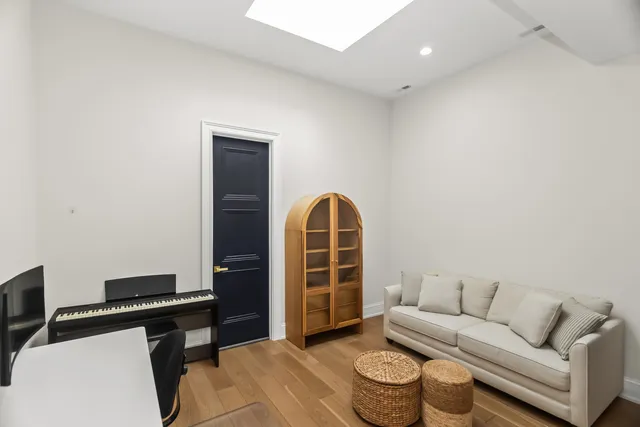 a living room with furniture a rug and a window