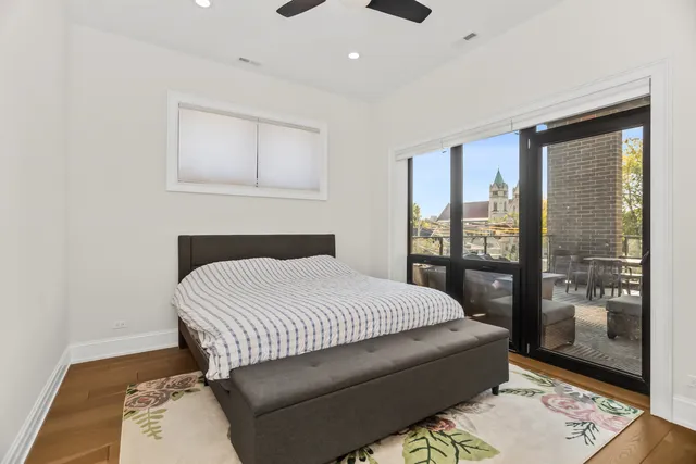 a bedroom with a bed and glass door