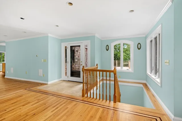 a view of outdoor space with wooden floor and windows