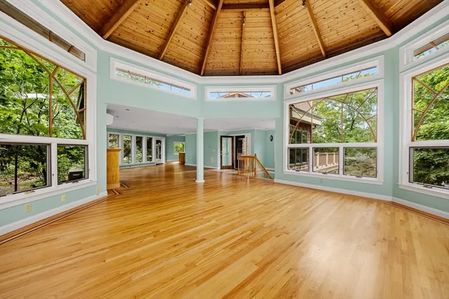 a view of swimming pool with wooden floor and seating space