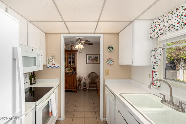 a kitchen with a sink cabinets and window