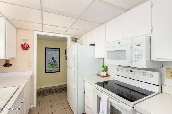 a kitchen with refrigerator cabinets and wooden floor