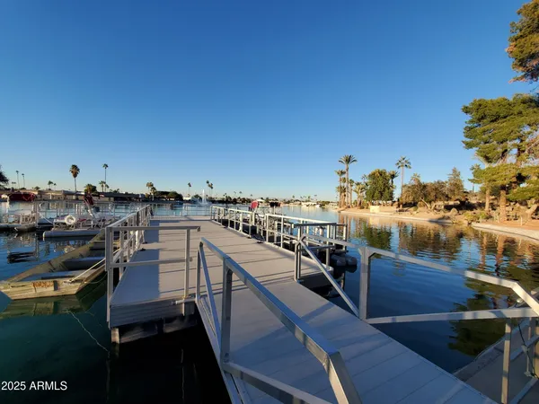 a view of a lake with boats and trees in the background