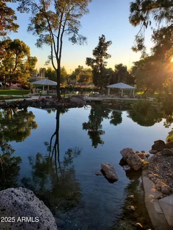 a view of a backyard with swimming pool and furniture