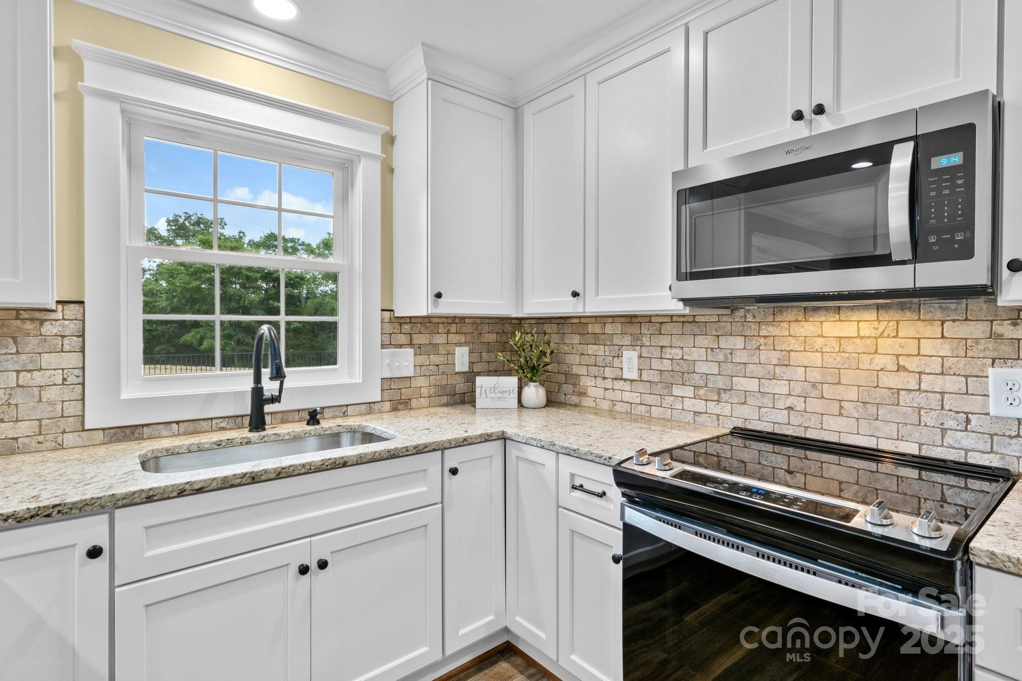 893 Chief Thomas Road Harmony, NC 28634 - Photo 13 of 38 a kitchen with a stove microwave and sink