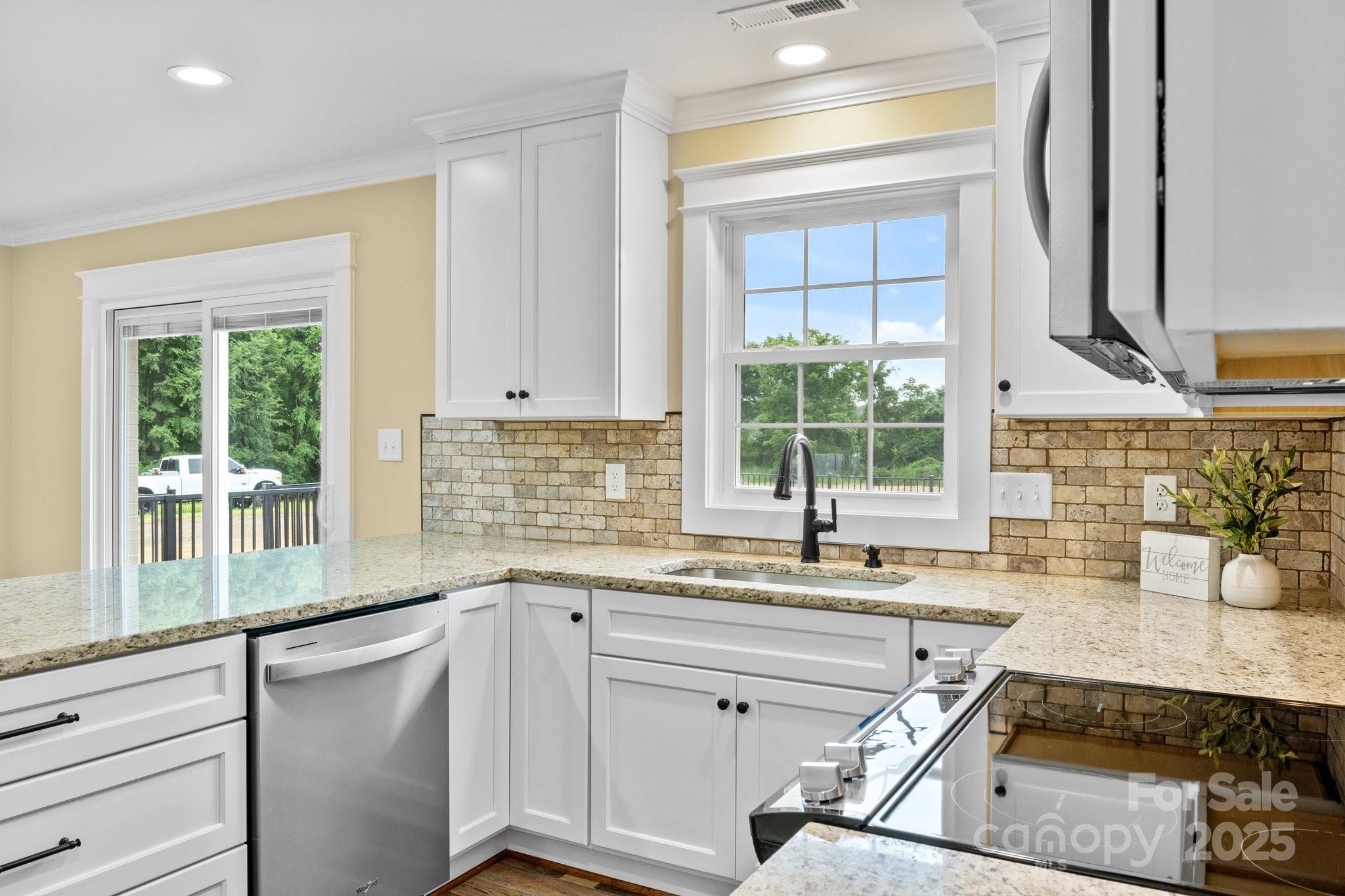 893 Chief Thomas Road Harmony, NC 28634 - Photo 15 of 38 a kitchen with a sink window and cabinets