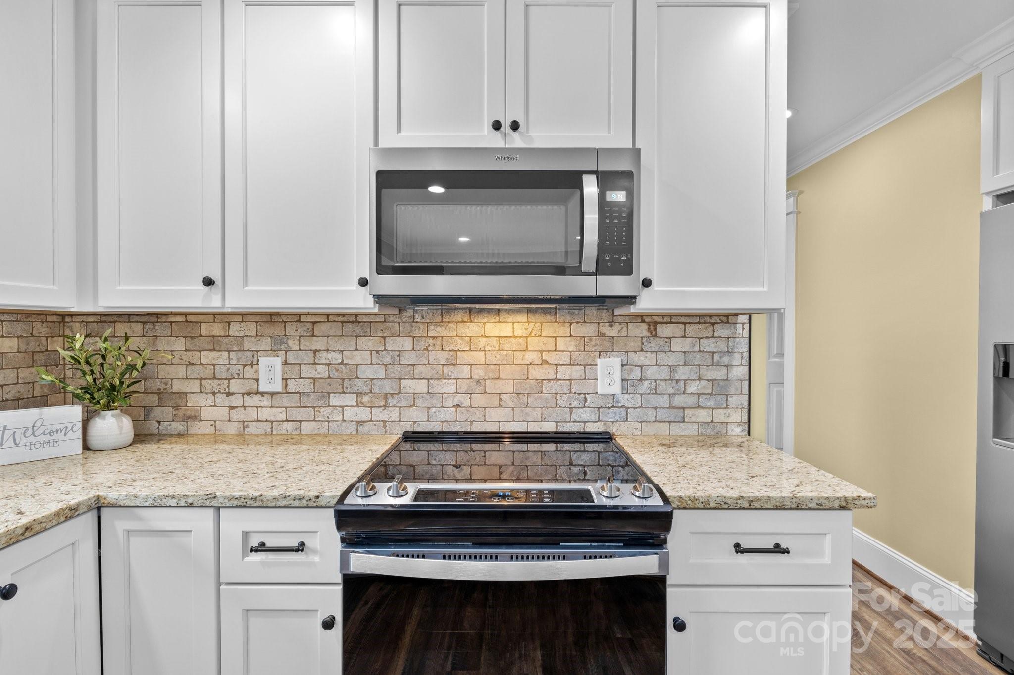 893 Chief Thomas Road Harmony, NC 28634 - Photo 16 of 38 a stove top oven sitting inside of a kitchen