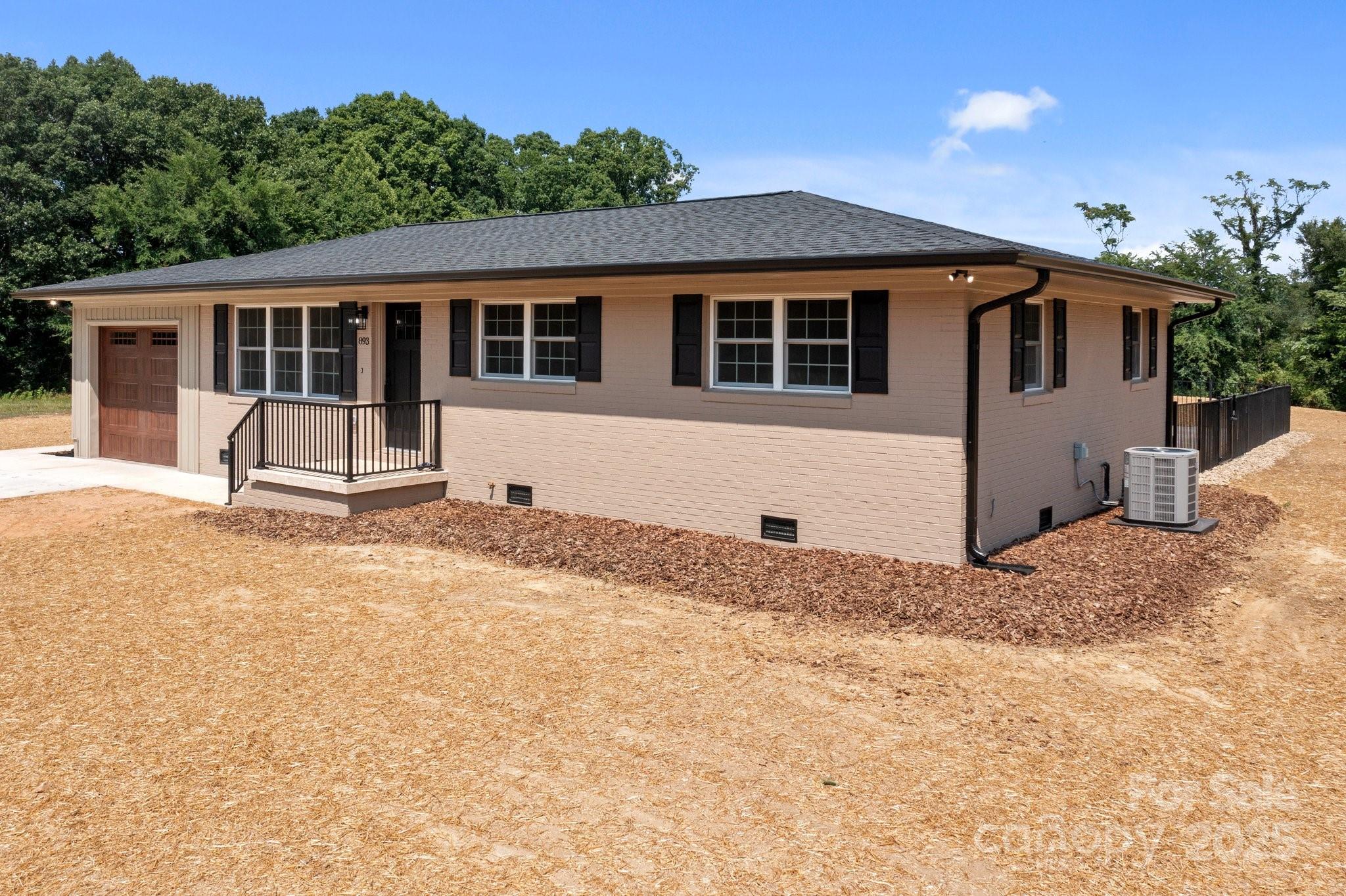 893 Chief Thomas Road Harmony, NC 28634 - Photo 3 of 38 a house with trees in the background