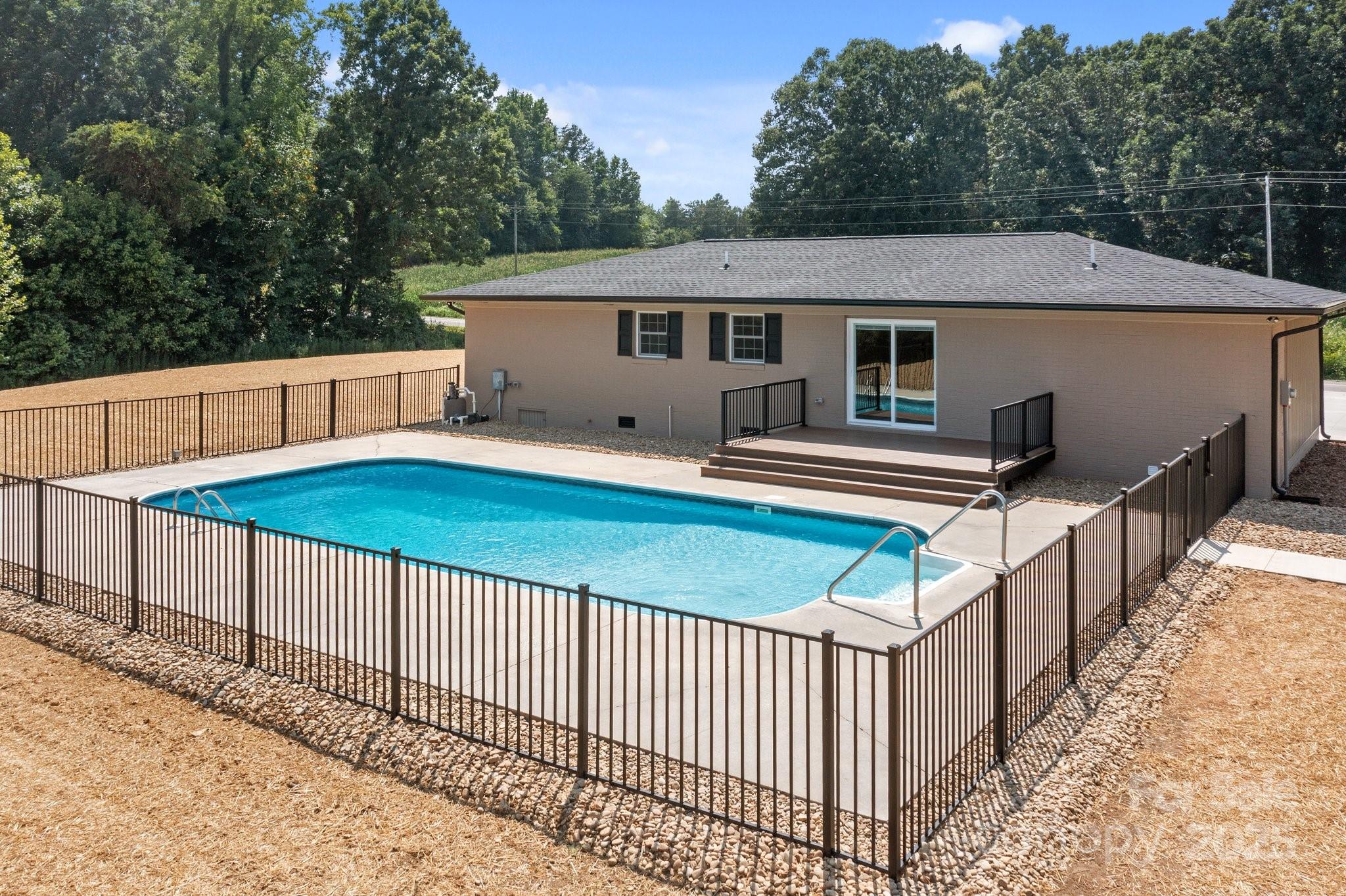 893 Chief Thomas Road Harmony, NC 28634 - Photo 32 of 38 a view of a house with backyard and sitting area