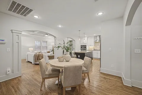 a dining room with furniture and wooden floor