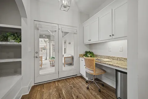 a workspace with white cabinets