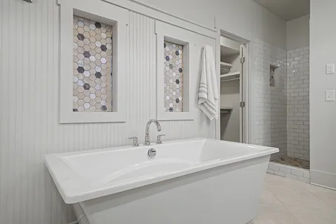 a bathroom with a sink a mirror and a shower