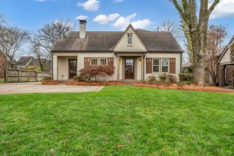 a front view of house with yard outdoor seating and green space