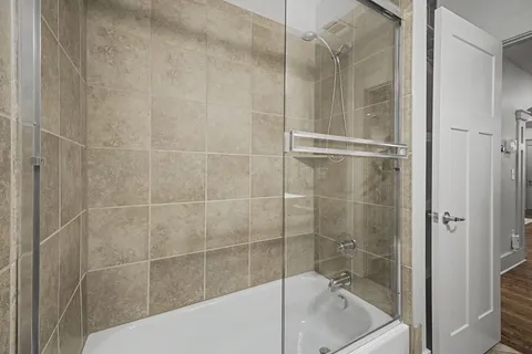 a bathroom with a bathtub and a shower