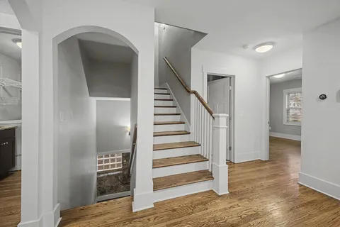a view of entryway and hall with wooden floor