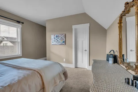 a bedroom with a bed and a dresser